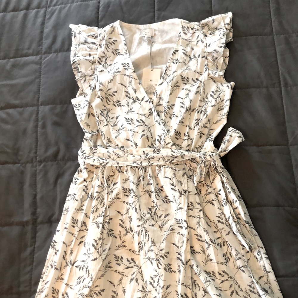 NEW with TAGS A New Day faux wrap white dress with black floral design.